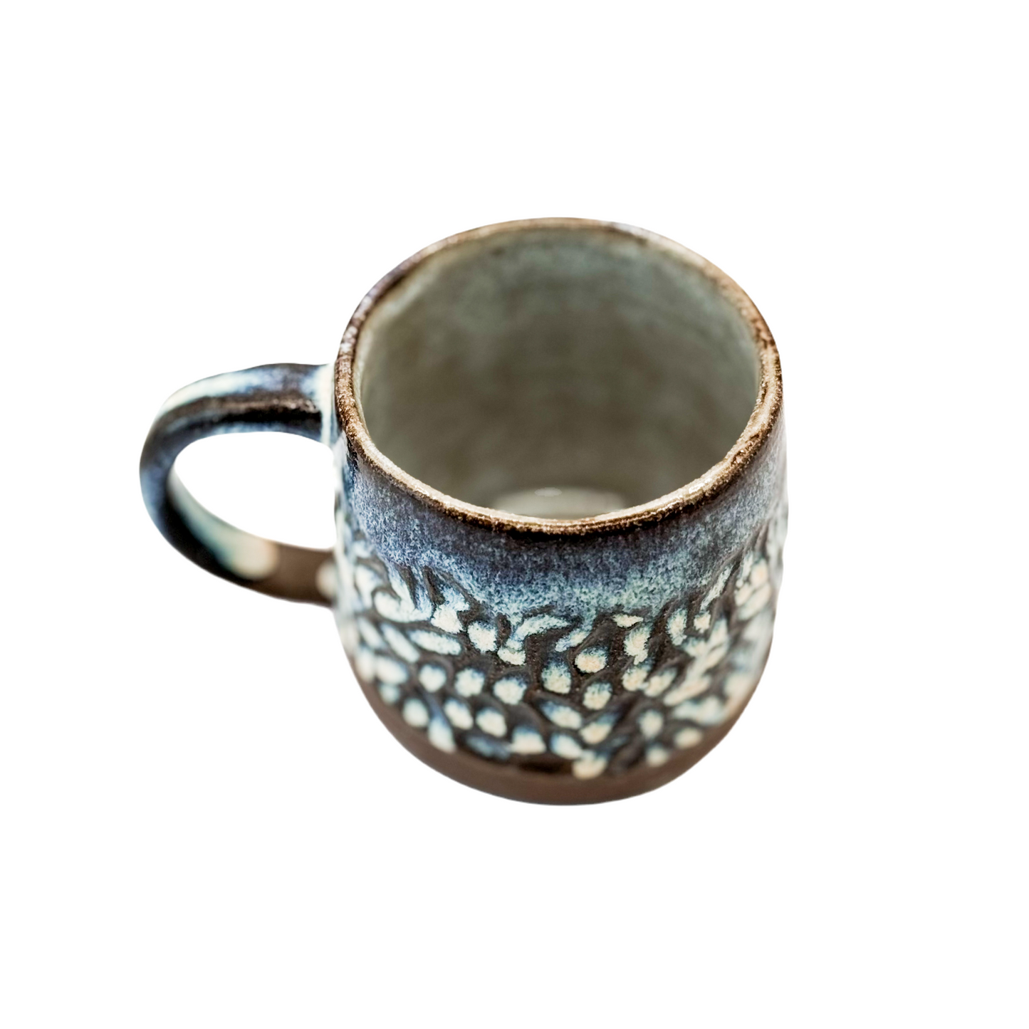 Carved Mug on Dark Clay